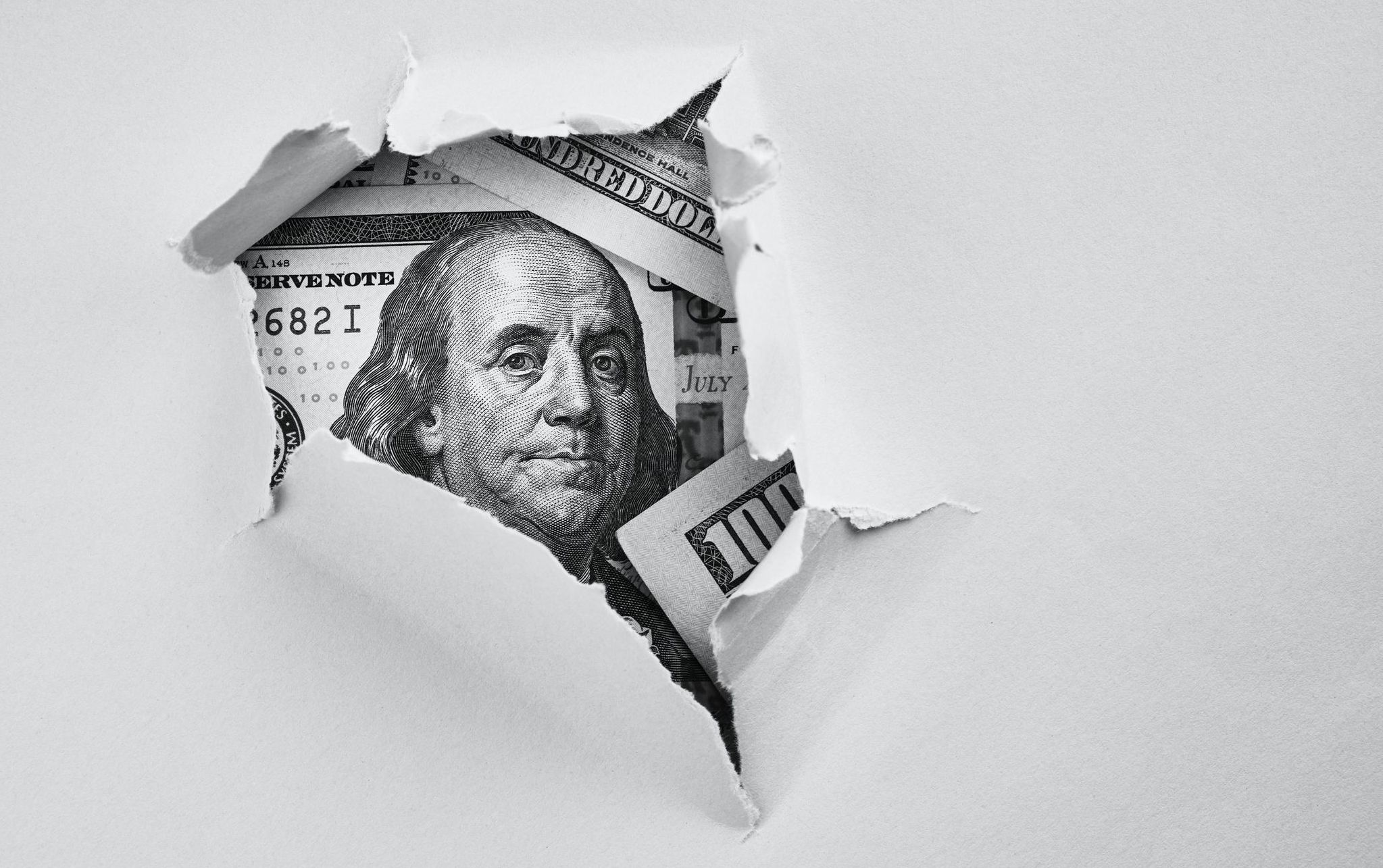blog head image of money peeking out of ripped paper